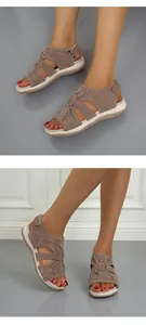Detail view showing breathable flat brown sandals with a comfortable open-toe design
