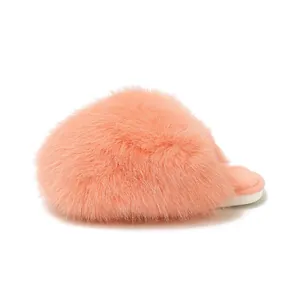 Close-up detail view of fluffy peach-colored faux fur indoor slippers with soft white soles