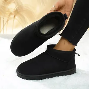 Detail view of black women's snow boots showing thick plush lining and soft suede upper