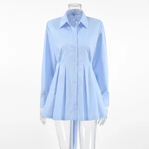 Front view of light blue cotton long sleeve shirt with pleated peplum waist design.