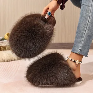 Detailed view of brown fluffy faux fur slippers for women in a cozy home setting