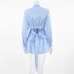 Detail of light blue cotton shirt featuring a stylish cut-out back with a large bow tie.