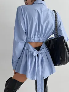 Detail view of light blue cotton long sleeve shirt with back bow tie and cutout