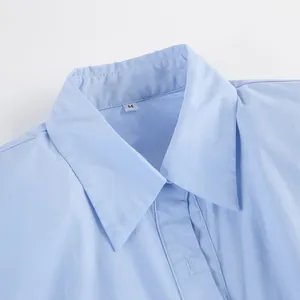 Close-up detail view of a classic light blue cotton shirt collar with visible M size tag