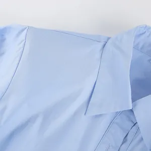 Macro view of light blue pure cotton shirt collar and delicate shoulder seam detail