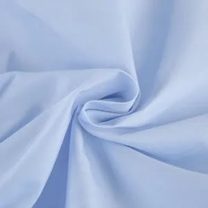 High-quality light blue cotton shirt fabric texture detail with elegant soft folds