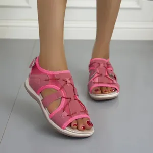 Detail shot of breathable pink sporty flat sandals with open-toe design on model feet