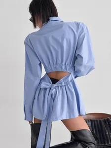 Stylish light blue cotton shirt with a unique bow tie back cutout design for women.