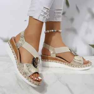 Stylish women's gold snakeskin wedge sandals with metal buckle and peep toe design