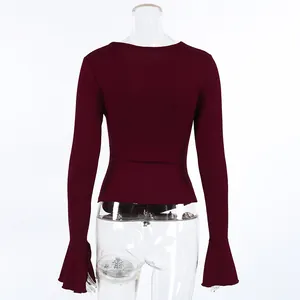 Detaillierte Rückansicht eines weinroten Langarmshirts mit ausgestellten Glockenärmeln.