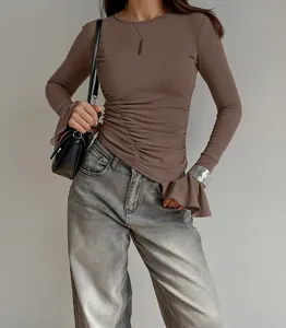 Nahaufnahme eines braunen Langarmshirts mit geraffter Taille und schicken Ärmeln