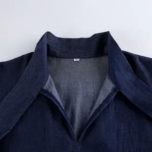 Close-up detail showing the collar and size tag of a soft blue cotton denim shirt.