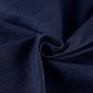 Close-up of soft dark blue cotton denim fabric showing texture and weave detail