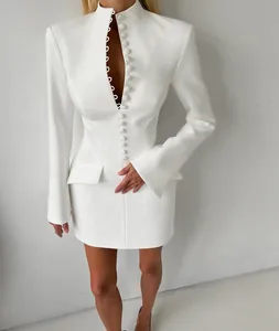 Detail view of a white blazer dress featuring a stand collar and button-down front.