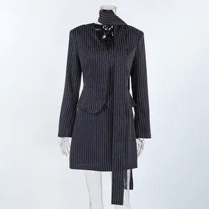 Detail view of a navy pinstripe two-piece suit set featuring a blazer and mini skirt