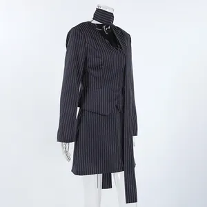 Detailed side view of navy pinstripe halter neck blazer and mini skirt suit set