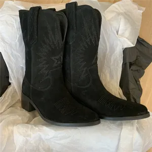 Vintage black suede Western cowboy boots with intricate sunburst embroidery detail