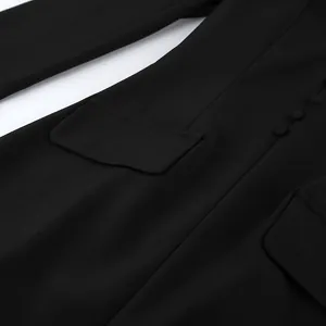 Close-up detail of a black slim fit blazer dress featuring flap pockets and round buttons