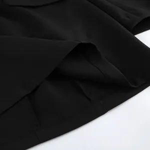 Macro view of high-quality hem stitching and fabric texture on a chic black blazer dress