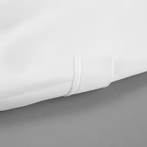 Close-up detail of the clean hem stitching on a white high-waist vintage A-line skirt