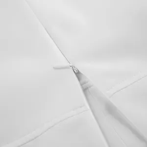 Close-up of high-quality invisible zipper on a white high-waisted A-line midi skirt detail.