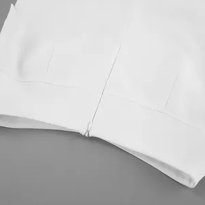 Close-up of invisible zipper detail on white high-waisted A-line skirt with smooth fabric texture.