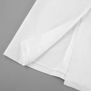 Close-up detail of white high waist straight skirt hem featuring a slit and inner lining
