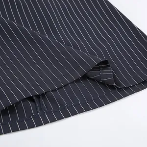 Close-up of navy blue pinstriped suit fabric showing hem detail and texture