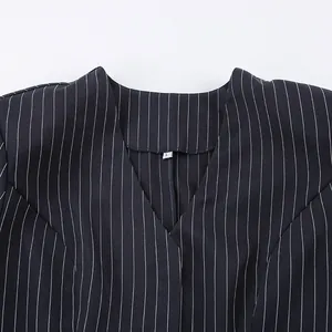 Close-up of navy pinstripe V-neck blazer collar showing size L tag and fabric texture