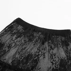 Close-up detail of high-waisted black lace skirt showing floral pattern and elastic waistband