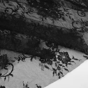 Detailed macro shot showing intricate black floral lace pattern on breathable mesh fabric.