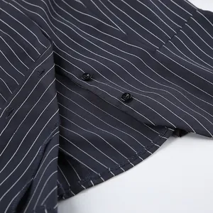 Macro detail of navy blue pinstripe blazer showing buttons and high-quality fabric texture
