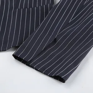 Close-up detail of vertical pinstripe pattern on a professional navy blue suit sleeve.