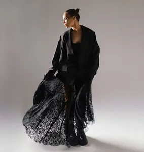 Editorial style photo of a black high-waisted lace sheer midi skirt with floral patterns