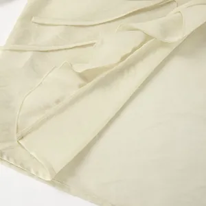 Detailansicht der cremefarbenen Rüschenbluse mit zarter Stofftextur und Rüschendetails