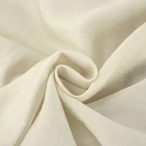 Makro-Detail von cremefarbenem französischem Stoff mit weicher Textur und Falten