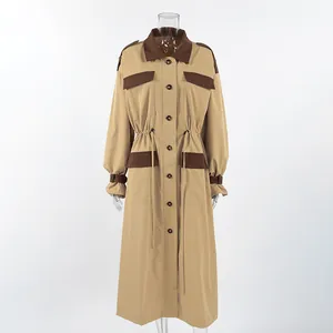 Macro view of khaki long trench coat featuring brown color-blocking and drawstring waist