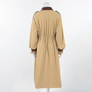 Back view of a khaki long oversized trench coat with brown collar and cuff details