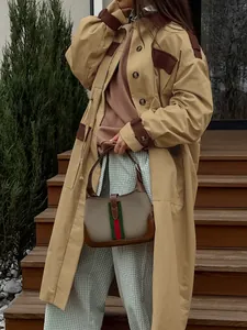 Detail of a khaki barn jacket style long coat with contrast brown collar and cuffs