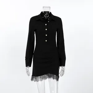 Close-up of black slim fit shirt dress featuring elegant lace trim and pleated waist.