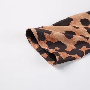 Detailed macro view showing the stitched cuff and leopard print texture of knitted bodysuit
