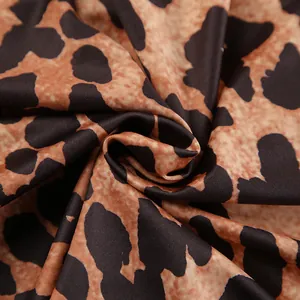 Close-up of soft leopard print knit fabric showing detailed texture and pattern.