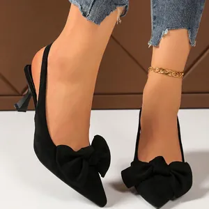 Elegant black slingback pumps featuring a stylish bow detail and kitten heel for women