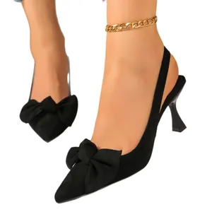 Elegant black slingback high heels featuring a large bow detail and pointed toe design