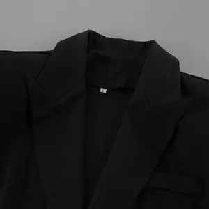 Close-up detail of the classic notch lapel and collar on a black women's blazer