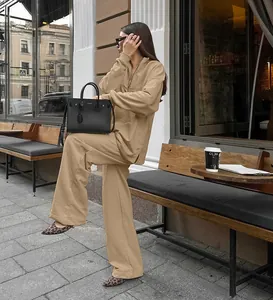 Professional lifestyle photo of a khaki two-piece sweatshirt set in urban street