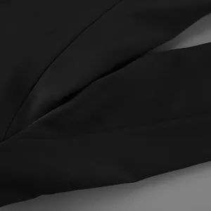 Macro view of high-quality smooth black fabric and seam detail on a women's fashion blazer.