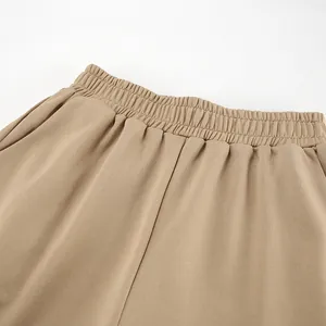 Macro detail view of the elastic waistband on khaki loose casual sweatpants for autumn.