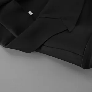 Close-up detail view of elegant black V-neck blazer jacket collar and size L inner tag