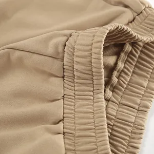 Close-up detail of khaki elastic waistband showing high-quality knitted fabric texture